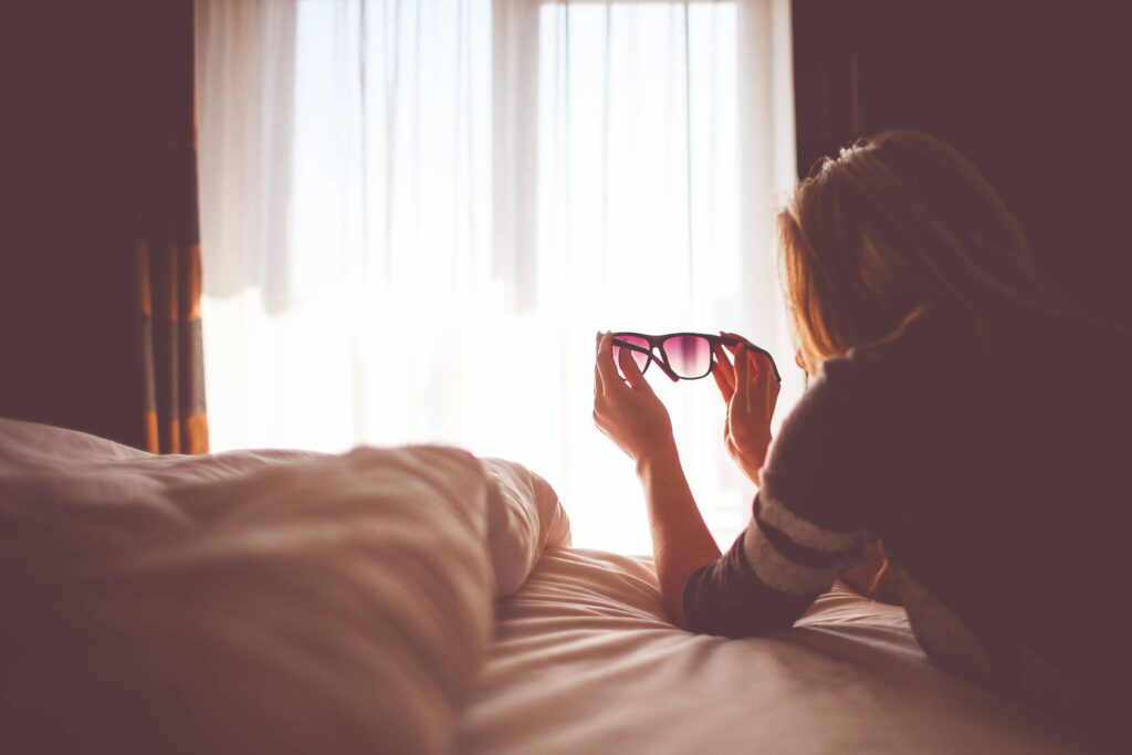 Girl with Sunglasses in a Bed Free Photo