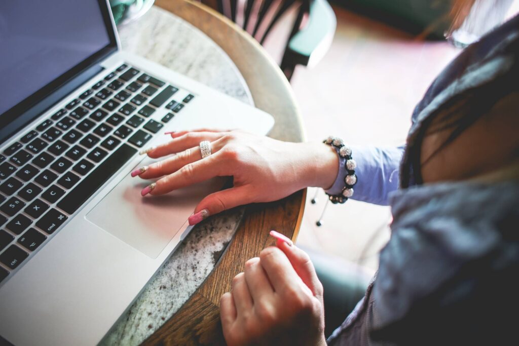 Girl Working on her MacBook in Caffe Free Photo