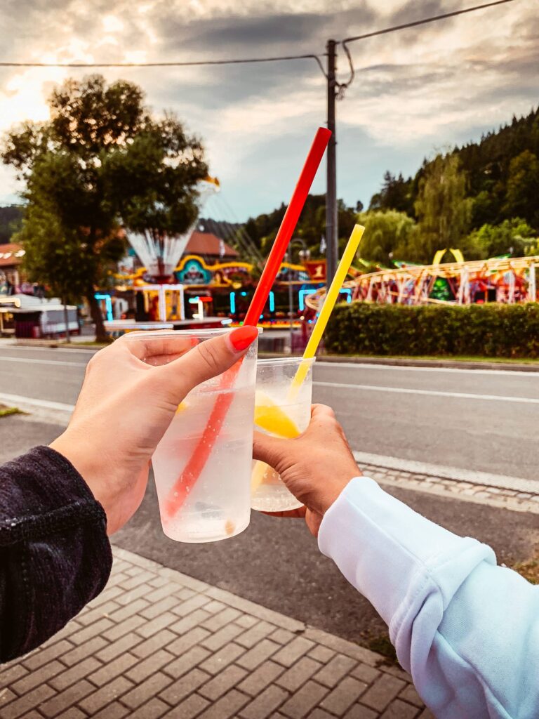 Girls Holding Drinks on Fun Fair Free Photo