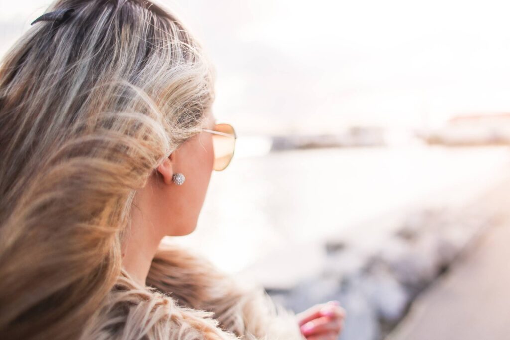 Glamorous Woman with Curly Hair and Sunglasses Free Photo