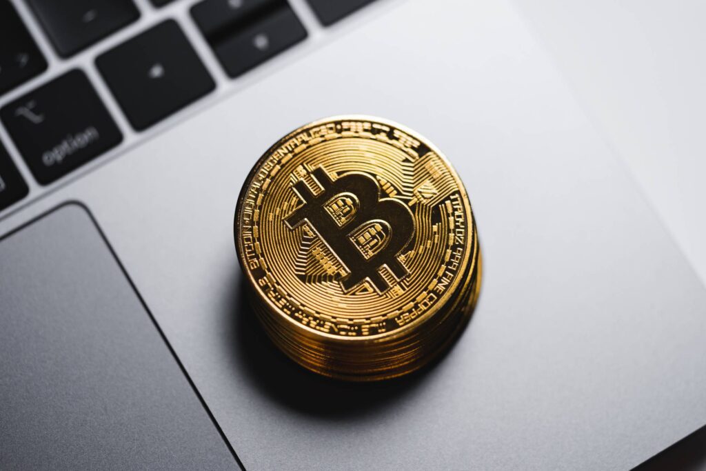 Gold Bitcoin on The MacBook Keyboard Free Photo