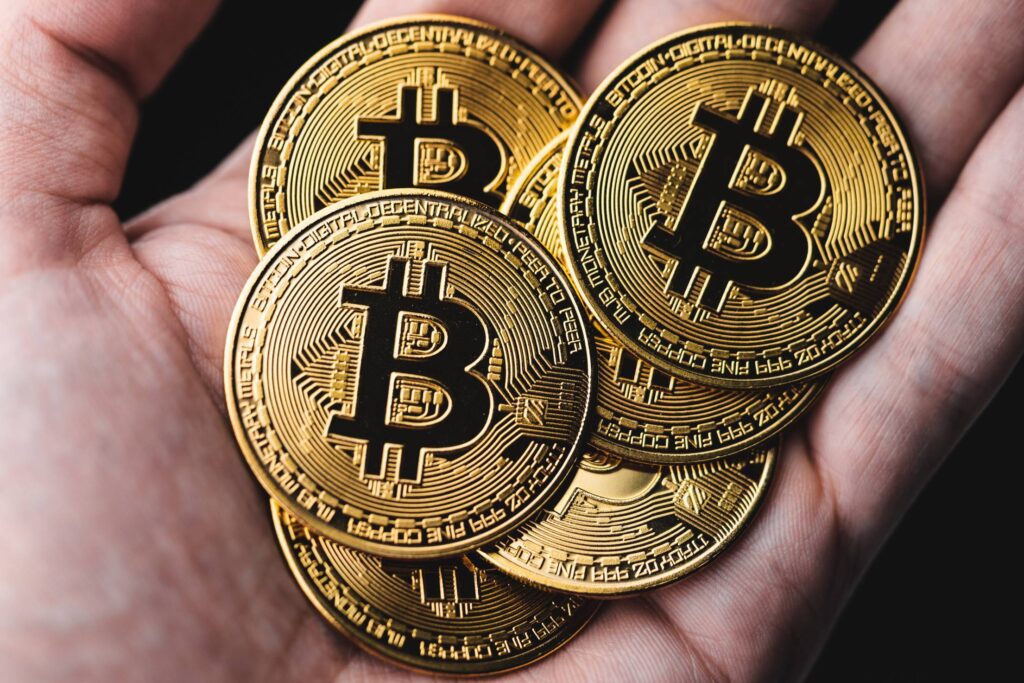 Gold Bitcoins in a Hand Free Photo