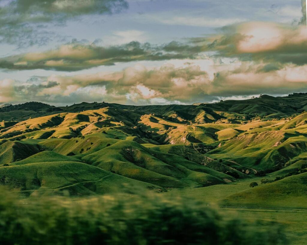 Green mountains under white clouds during daytime Free Photo