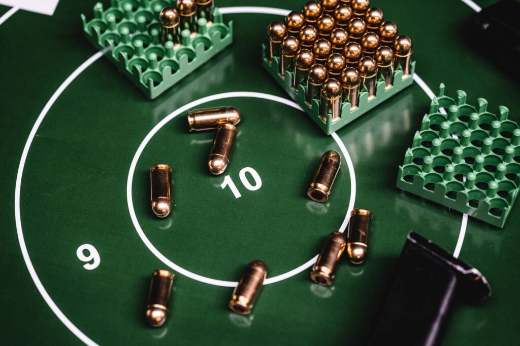 Green Shooting Target with a Lot of 9mm Ammunition Free Photo