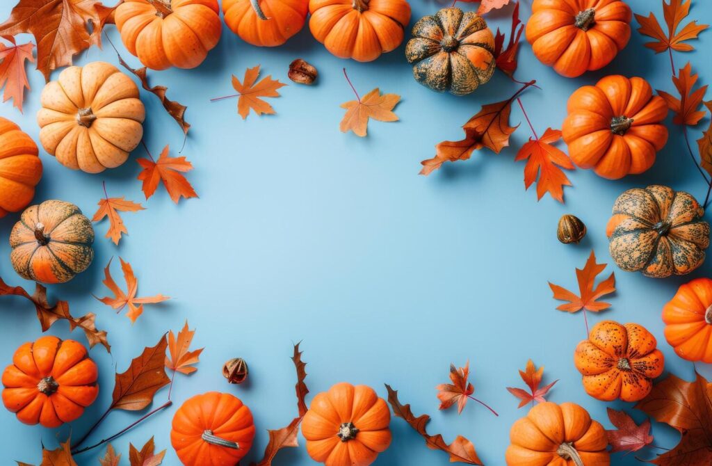 Group of Pumpkins and Leaves on Blue Background Stock Free