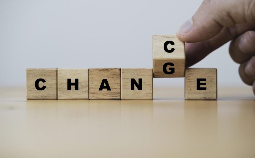 
									Hand flipping of wooden cube block between change and chance for positive thinking mindset concept. Stock Free
