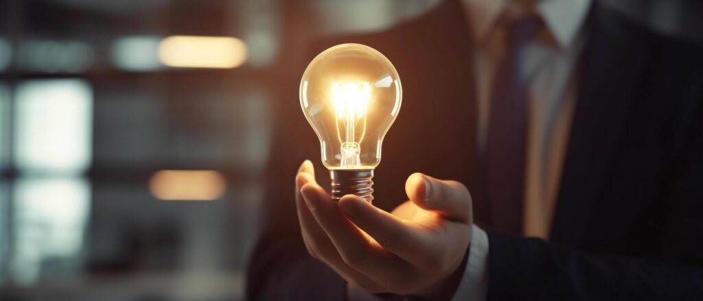 hand of business man holding light bulb with Innovation and business idea for analysis to work, Stock Free