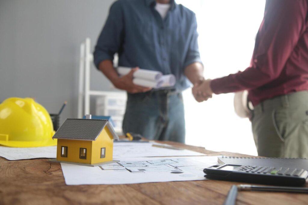 Handshake. Close up construction worker people shaking hands on business cooperation agreement. Successful hands shaking after good deal Stock Free