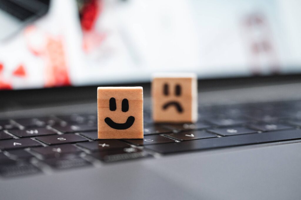 Happy and Sad Smiley on Laptop Keyboard Free Photo