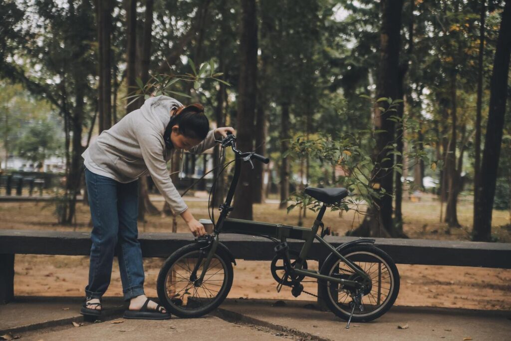 Happy Asian young woman walk and ride bicycle in park, street city her smiling using bike of transportation, ECO friendly, People lifestyle concept. Stock Free