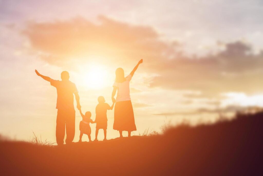 Happy family dancing on the road in the sunset time. Evening party on the nature Stock Free