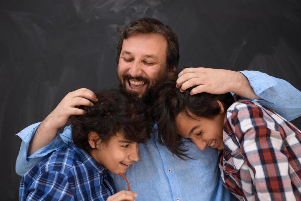 happy father hugging sons unforgetable moments of family joy in mixed race middle eastern arab family Stock Free