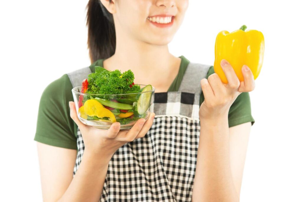 Happy lady holding kichen stuff over copy space background – people home made food preparation concept Stock Free