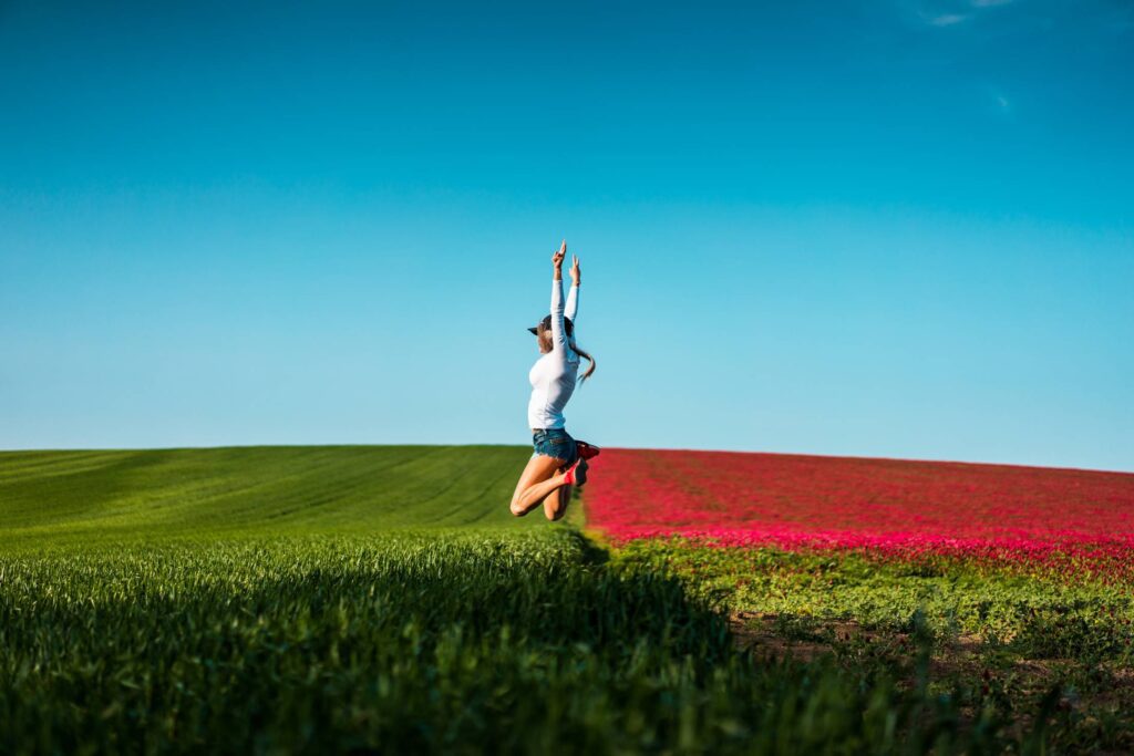 Happy Woman Jumping in the Air Free Photo