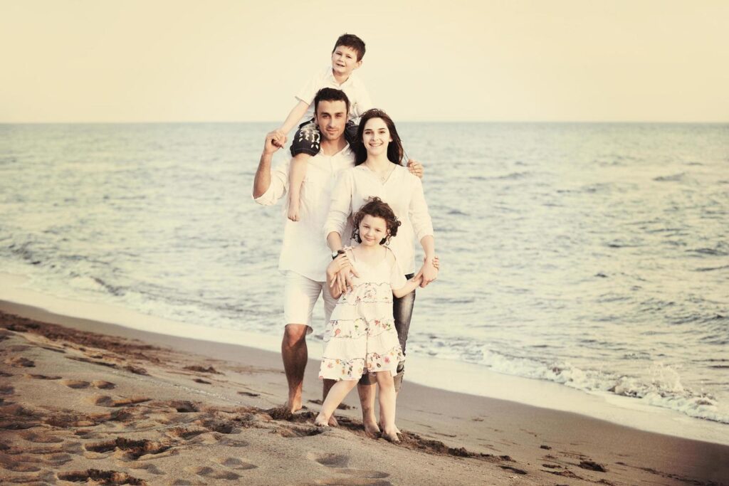 happy young family have fun on beach Stock Free