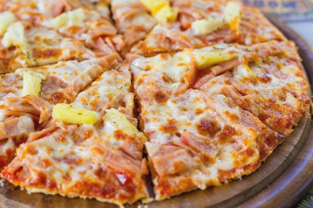 Hawaiian pizza is a Italian food which it made with tomato sauce, chopped pineapple, ham and cheese. Stock Free