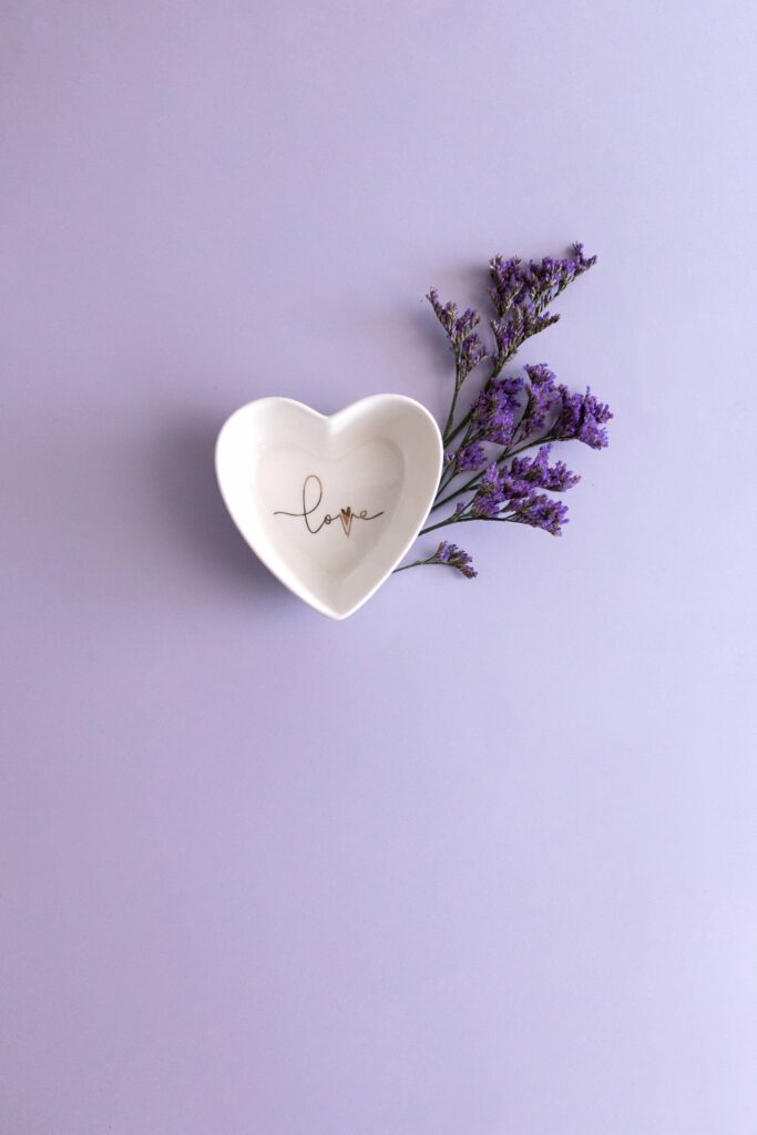 Heart Shaped Bowl with Flower on Purple Background Free Photo