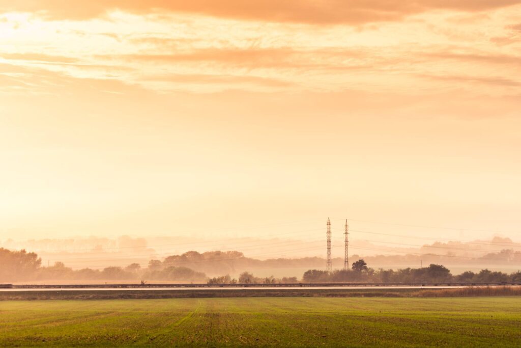 Highway Road and Electricity Pylons Foggy Golden Hour Free Photo