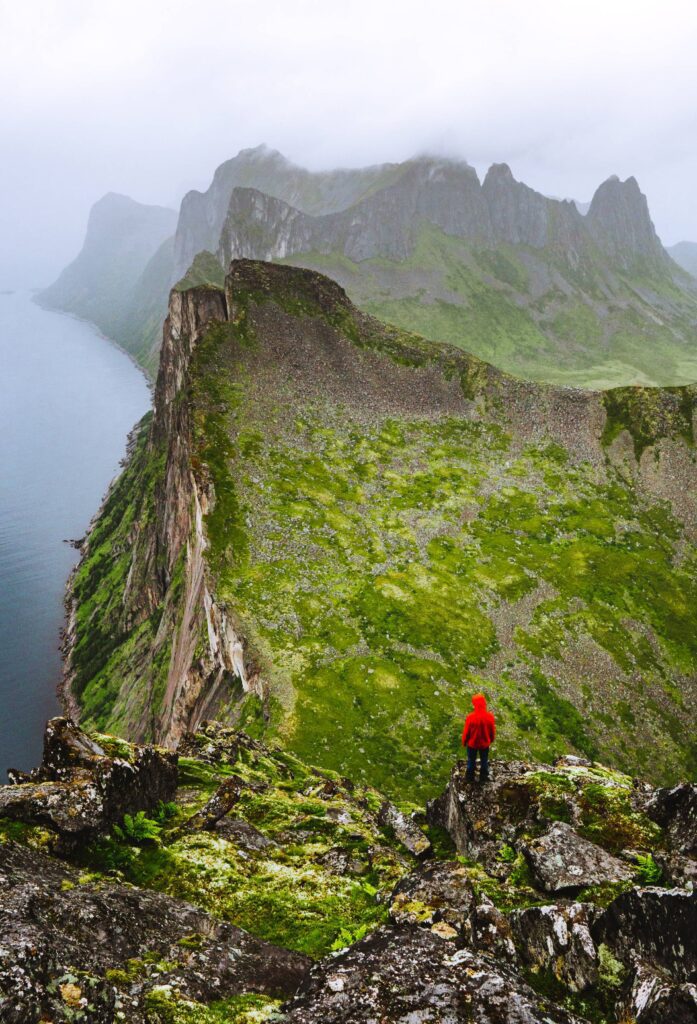 Hiker Enjoying the View on the Foggy Mountains Vertical Free Photo