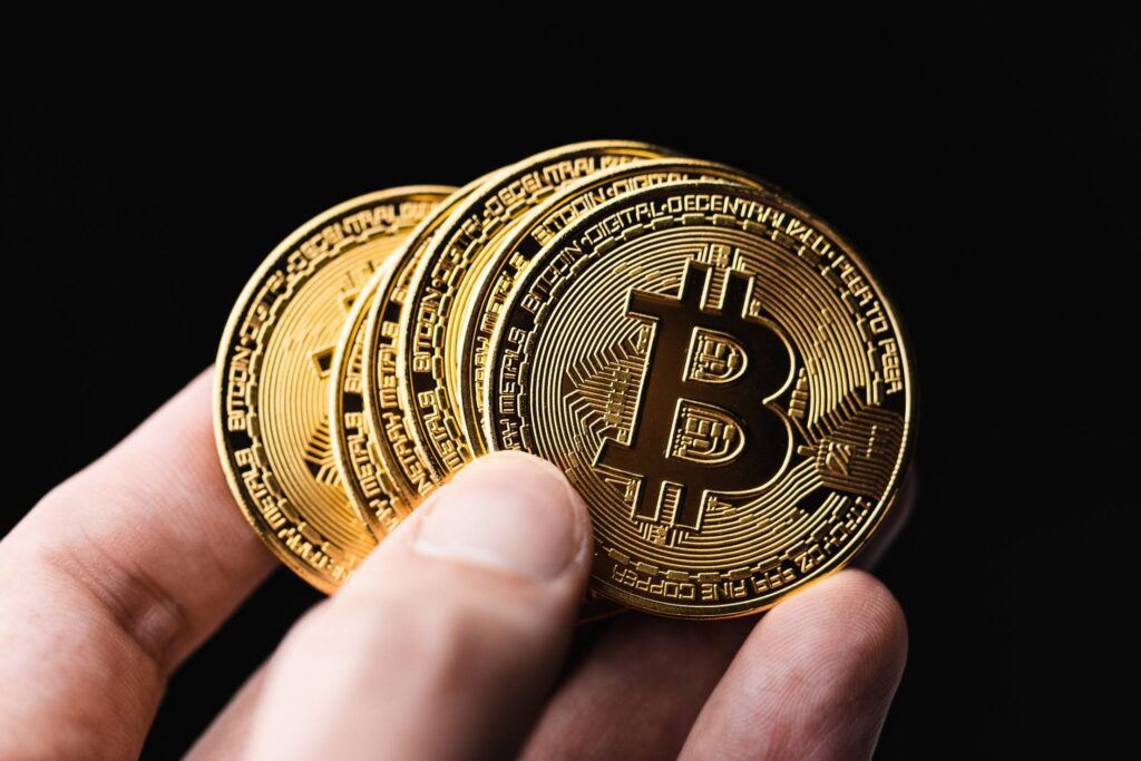 Holding Bitcoins in a Hand Free Photo