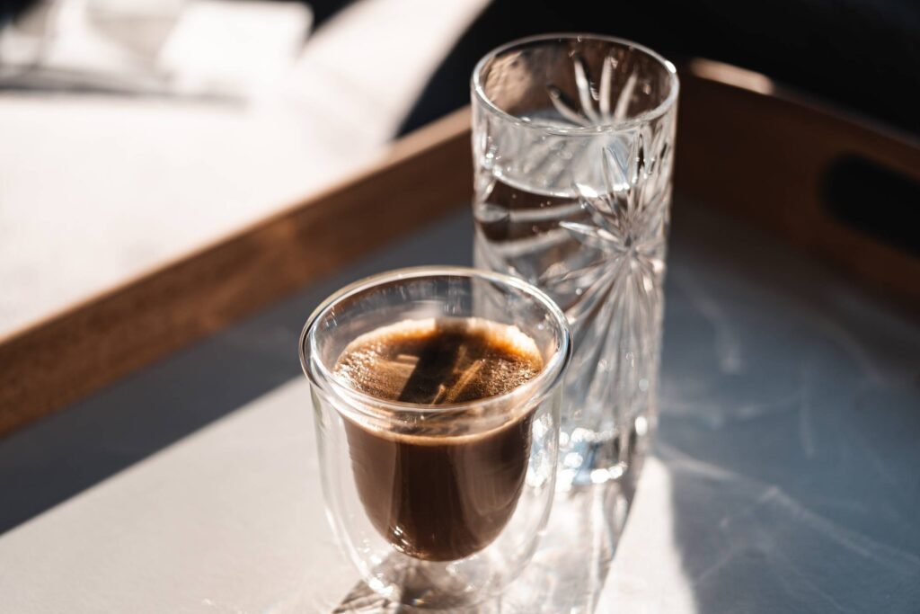 Homemade Lungo Coffee with a Glass of Water Free Photo