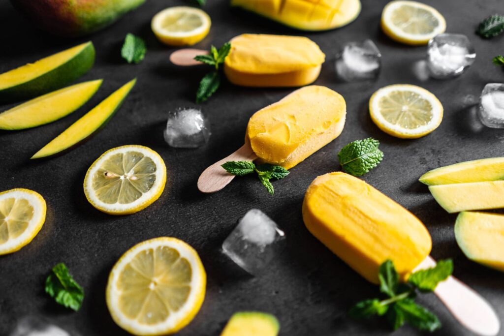 Homemade Mango Popsicles Decorated with Mint Leaves Free Photo