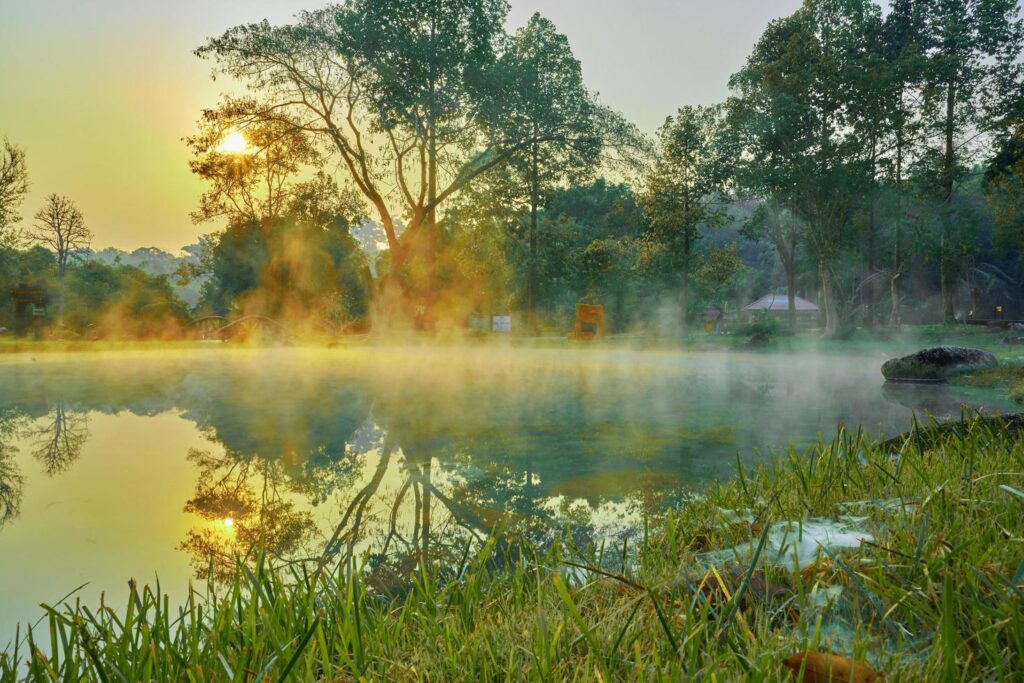 Hot Springs Onsen Natural Bath at National Park Chae Son, Lampang Thailand.In the morning sunrise.Natural hot spring bath surrounded by mountains in northern Thailand.soft focus. Stock Free