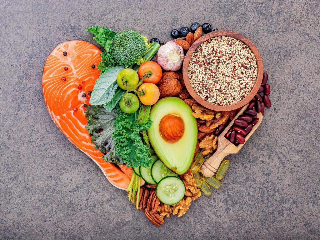 
									Ingredients for healthy foods selection on dark stone background in heart shape Free Photo