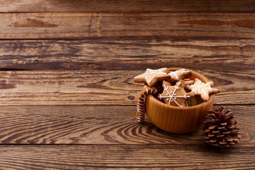 Knar and christmas food sweet cookies on wooden table background. Copy space. Selective focus. Happy new year concept. Stock Free