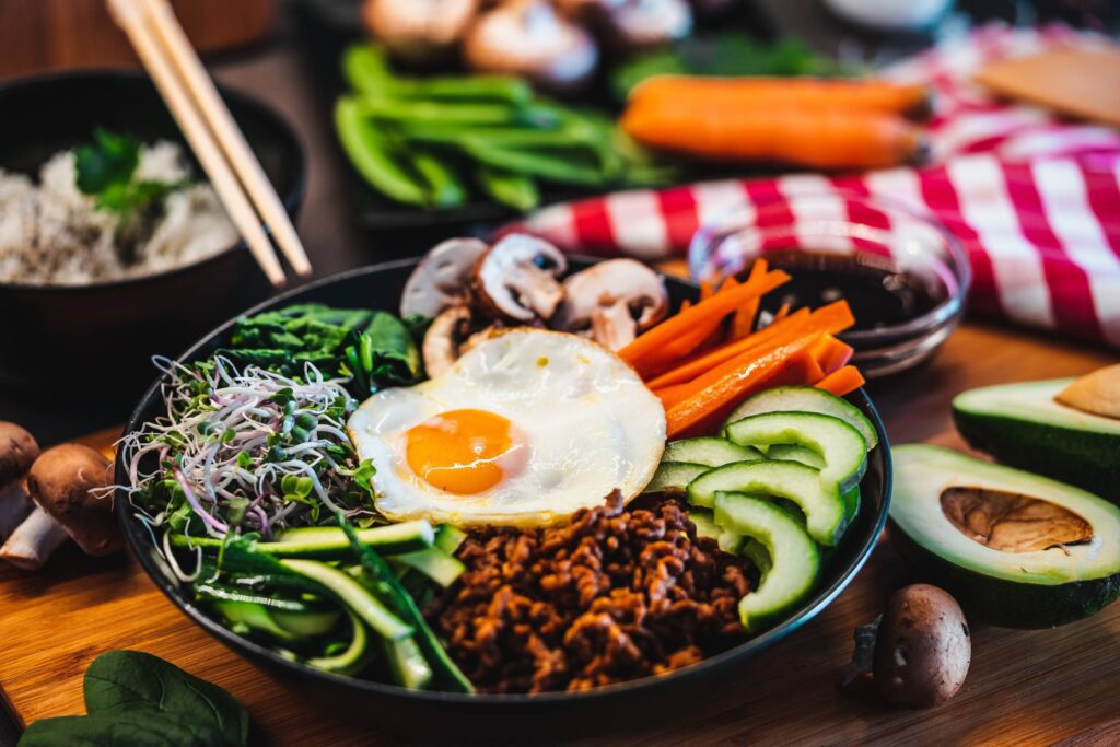 Korean Bibimbap Rice Dish Topped with a Fried Egg Free Photo