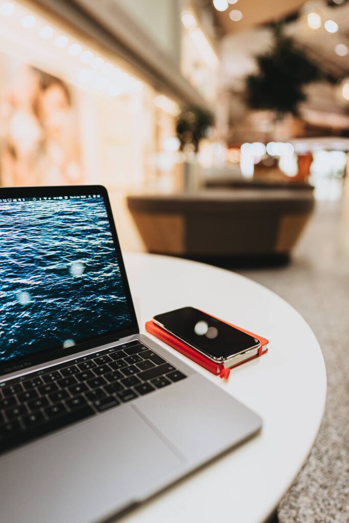 Laptop and Smartphone on a Table in Shopping Center Free Photo