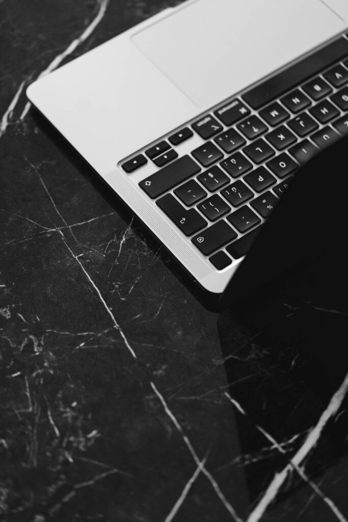 Laptop Keyboard Close Up on a Black Marble Table Free Photo