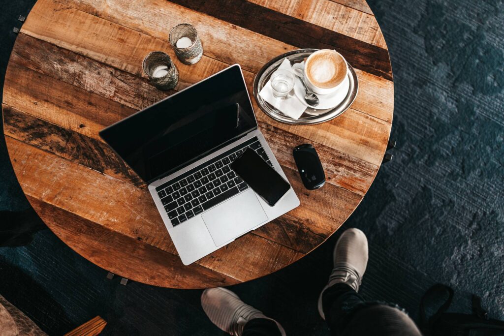 Laptop on a Round Wooden Table Flat Lay Free Photo