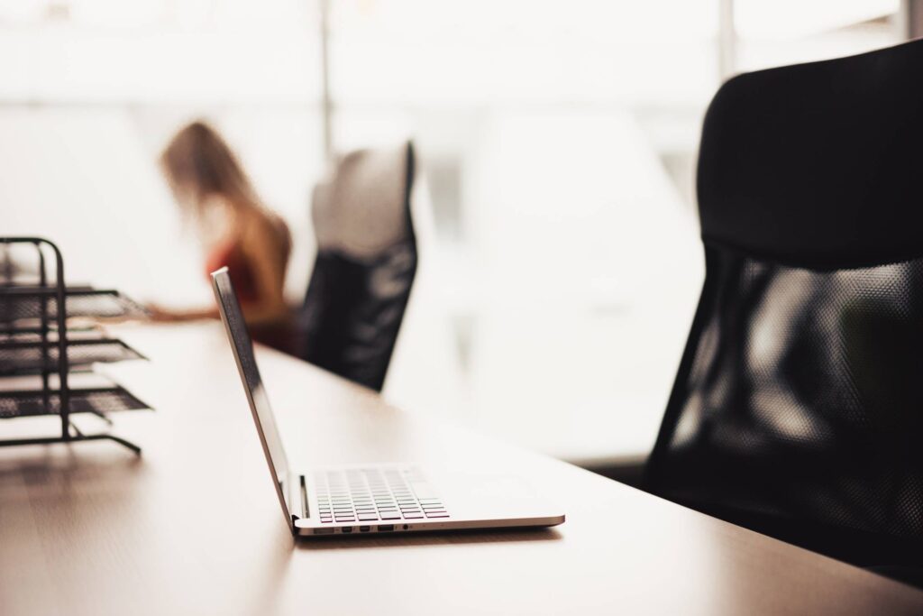 Laptop on Wooden Desk in Office Open Space Free Photo