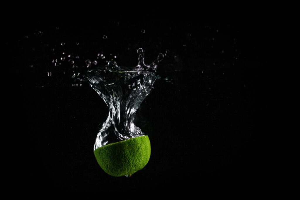 Lime In Water with Black Background Free Photo