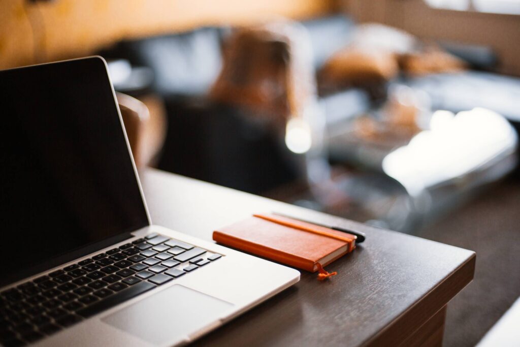 MacBook and Moleskine Diary Ready to Working Free Photo