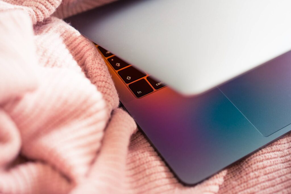 MacBook in Pink Sweater Free Photo