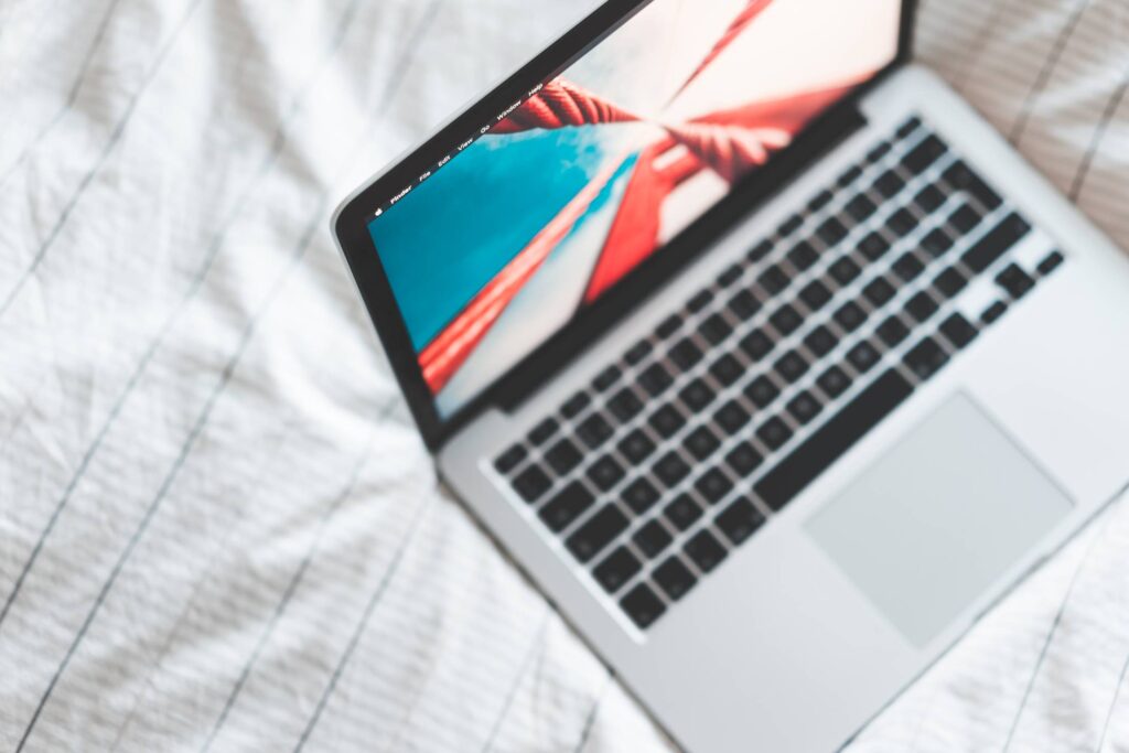 MacBook Laptop in Bed from Above Free Photo