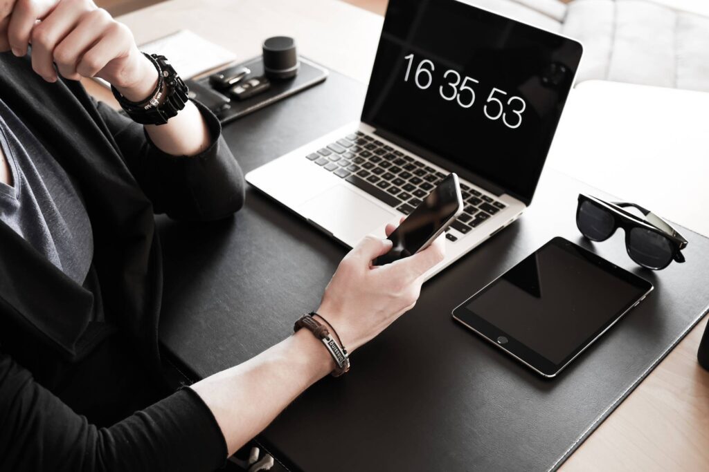 Man Checking His iPhone & Working at Home Office Free Photo