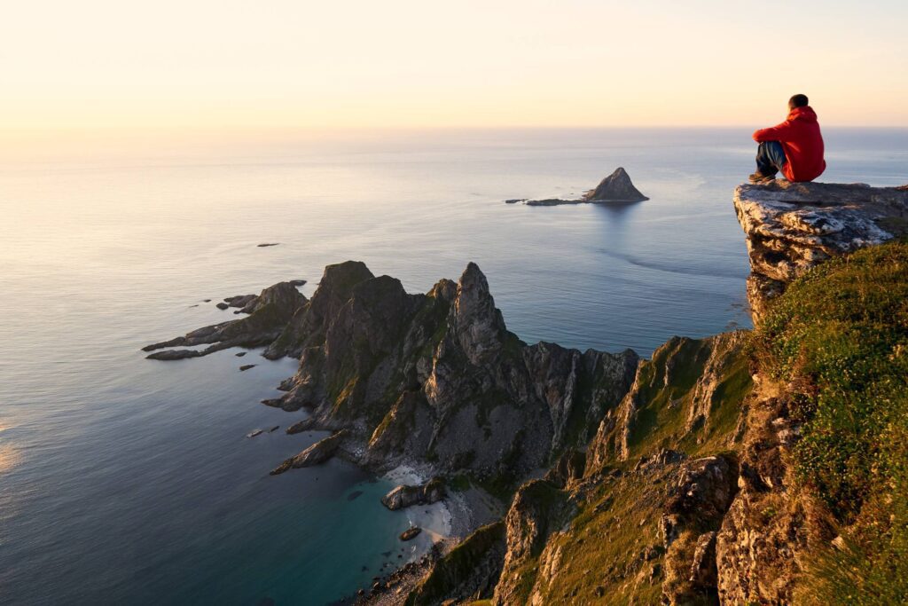 Man Enjoying the View from the Edge of the Cliff Free Photo