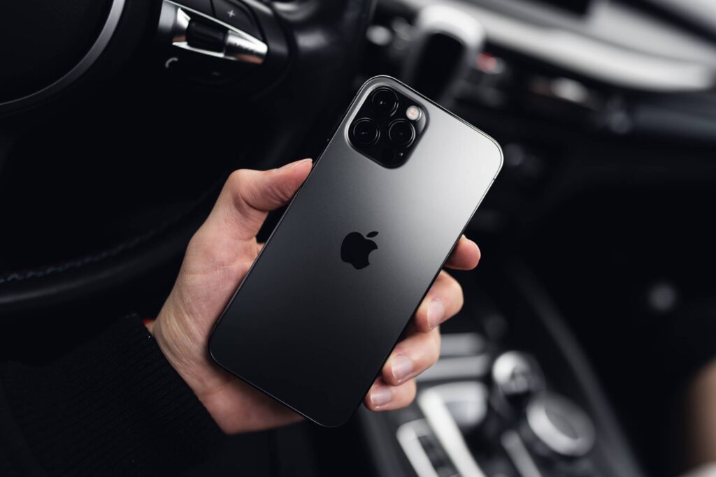 Man Holding a New iPhone 12 Pro in a Car Free Photo