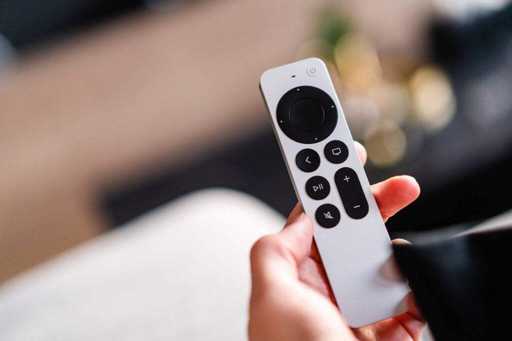 Man Holding Apple TV Remote Free Photo