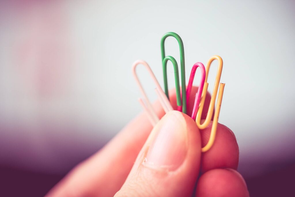 Man Holding Colorful Paper Clips Free Photo