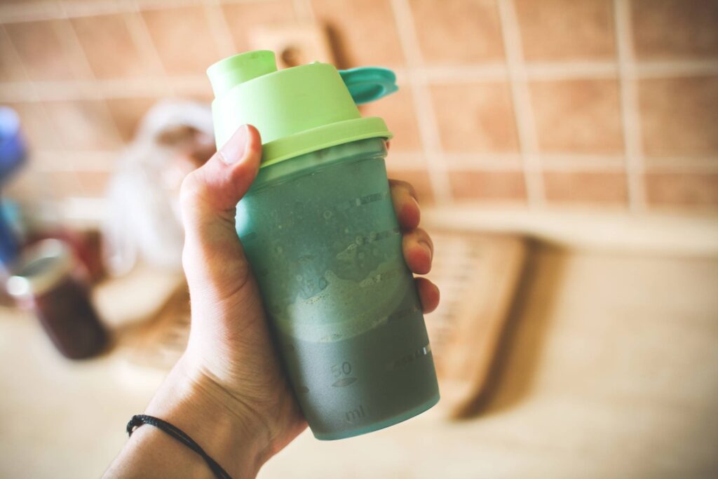 Man Holding Fitness Gainer/Protein Shake Free Photo