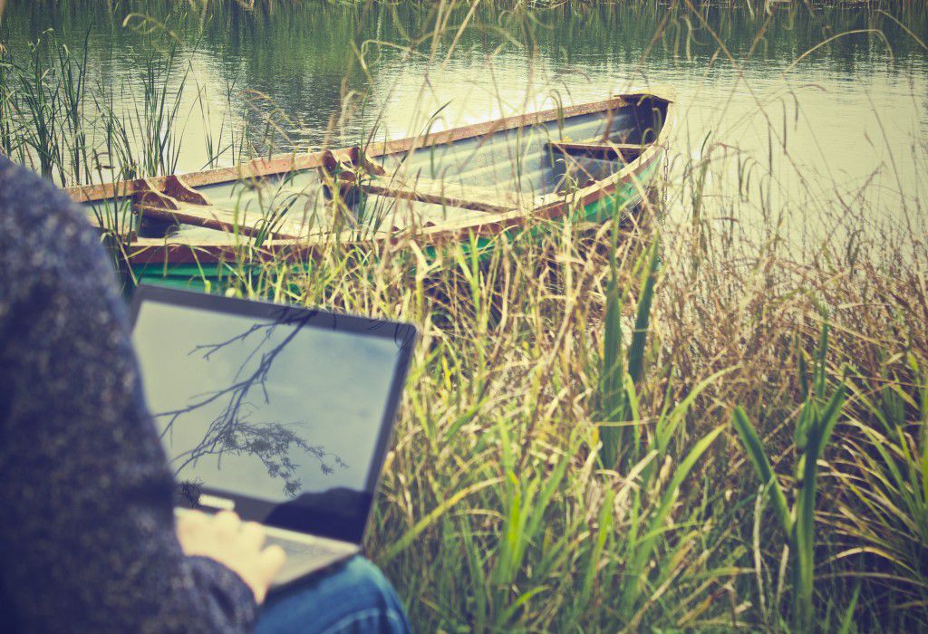 Man on Laptop with Boat Free Stock HD Photo