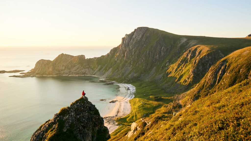 Man Looking at The Hidden Beach Between The Mountains Free Photo