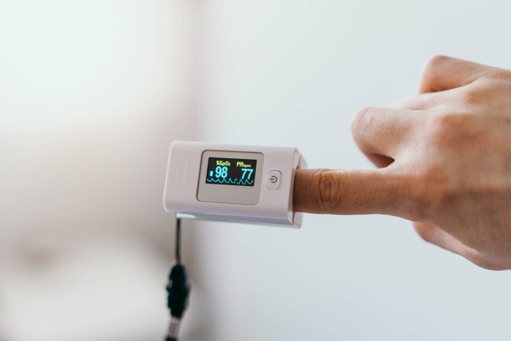 Man Measures His Oxygen Saturation with an Oximeter Free Photo