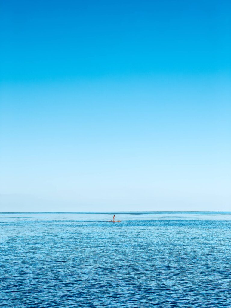 Man on a Paddleboard on the Open Sea Free Photo