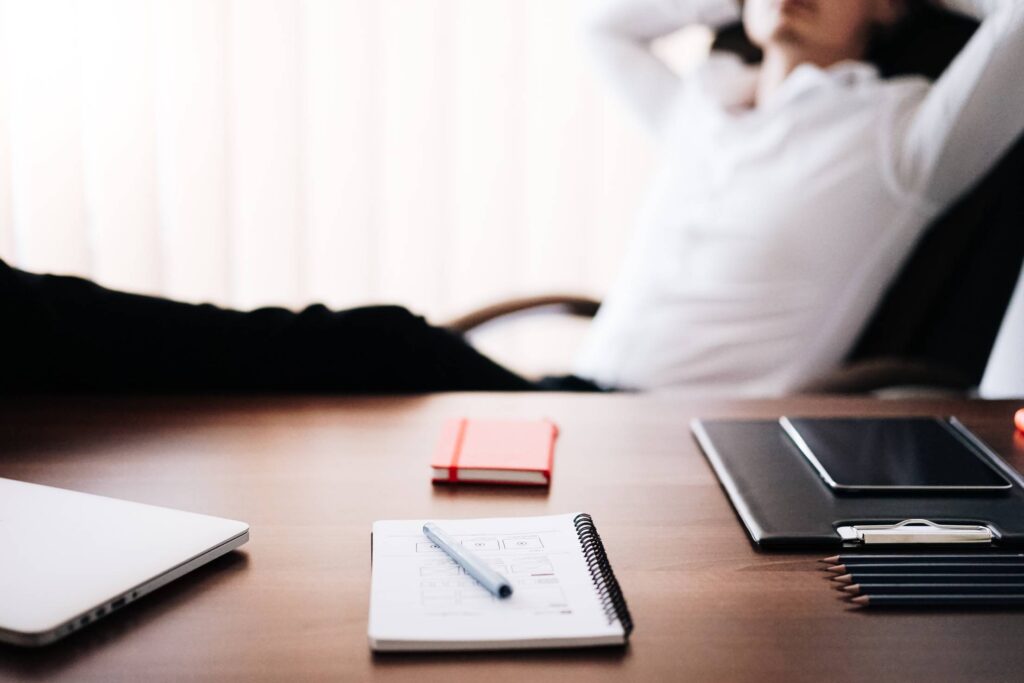 Man Relaxing in Office With Legs Up: All Work Done Free Photo