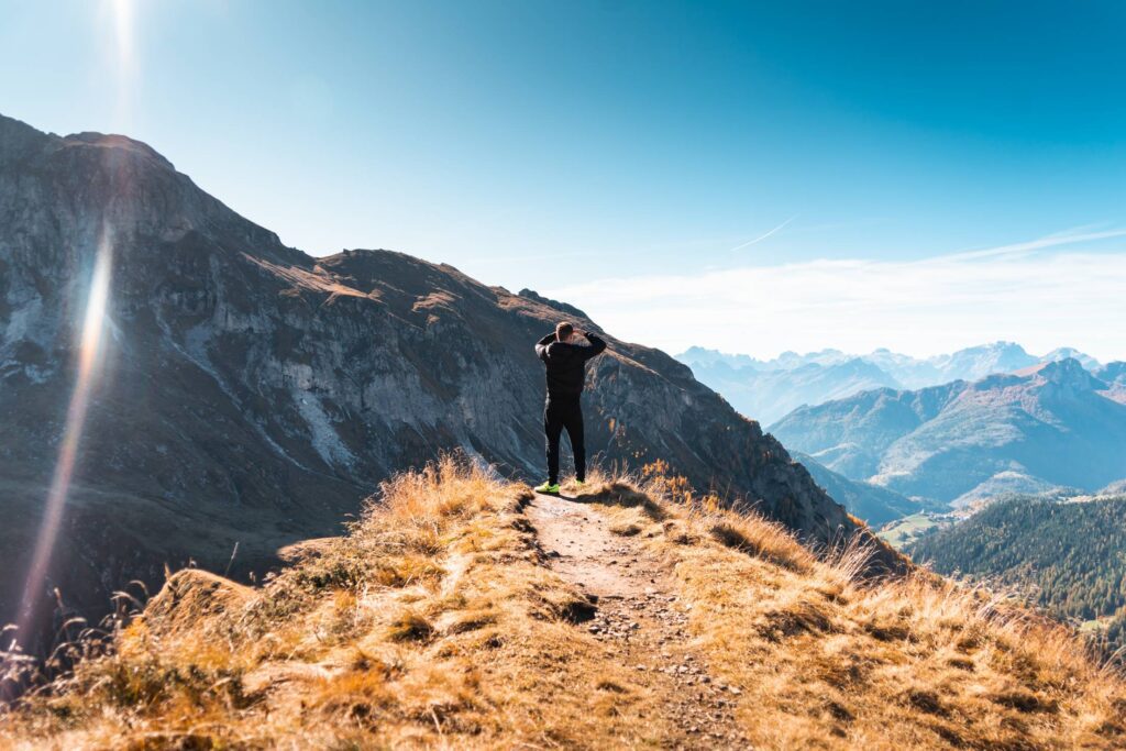 Man Standing on a Mountain and Looking out over The Scenery Free Photo